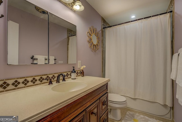 bathroom with tile patterned floors, vanity, shower / bathtub combination with curtain, and toilet