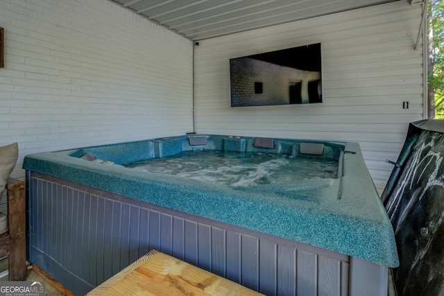 deck featuring an outdoor hot tub