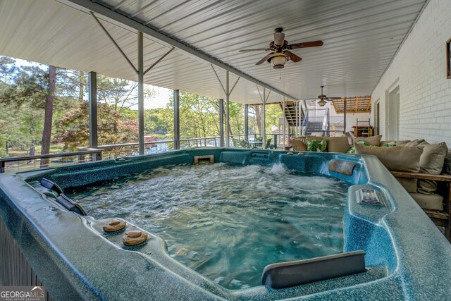 view of swimming pool featuring an indoor hot tub and a ceiling fan