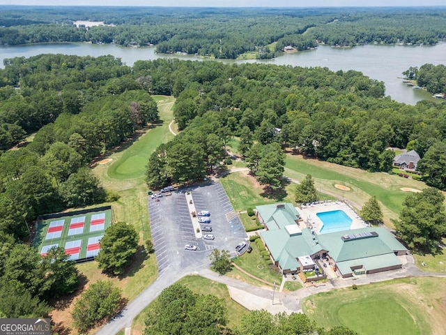 aerial view with a forest view, a water view, and golf course view