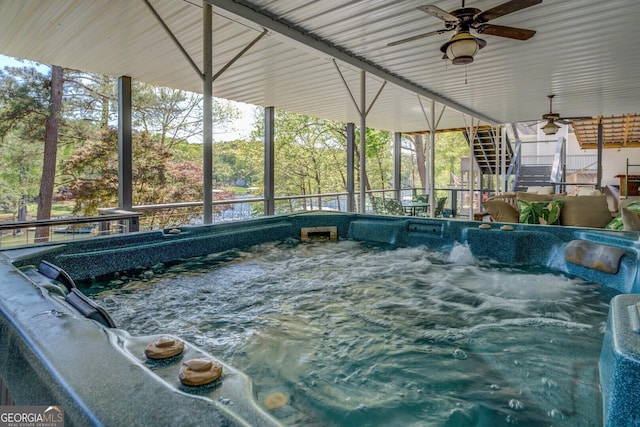 view of swimming pool featuring an indoor hot tub, stairs, and ceiling fan