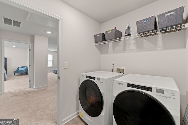 laundry room featuring laundry area, attic access, light carpet, visible vents, and washer and clothes dryer