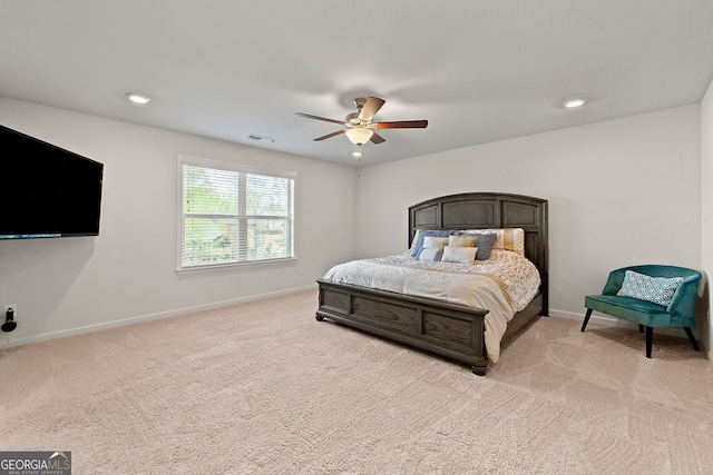 bedroom featuring baseboards, a ceiling fan, visible vents, and light carpet