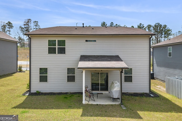 rear view of property with a patio and a lawn