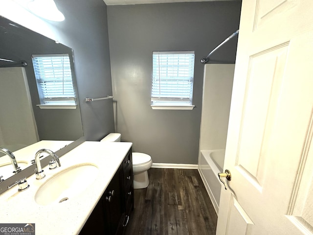 4254 Wood Cove Dr, Snellville, GA 30039 - bathroom with plenty of natural light, vanity, toilet, and wood finished floors