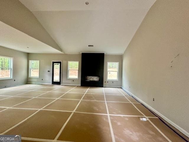 302 Lakeside Dr Lot 74, Lagrange, GA 30240 - unfurnished living room featuring a healthy amount of sunlight, vaulted ceiling, and baseboards