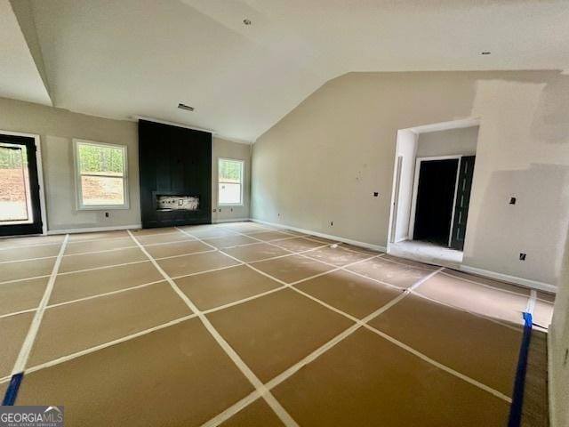 302 Lakeside Dr Lot 74, Lagrange, GA 30240 - unfurnished living room featuring a fireplace, visible vents, baseboards, vaulted ceiling, and tile patterned floors