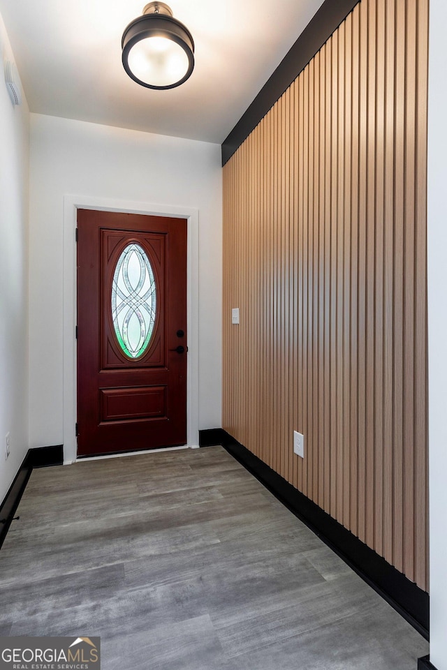 entryway with wood finished floors and baseboards