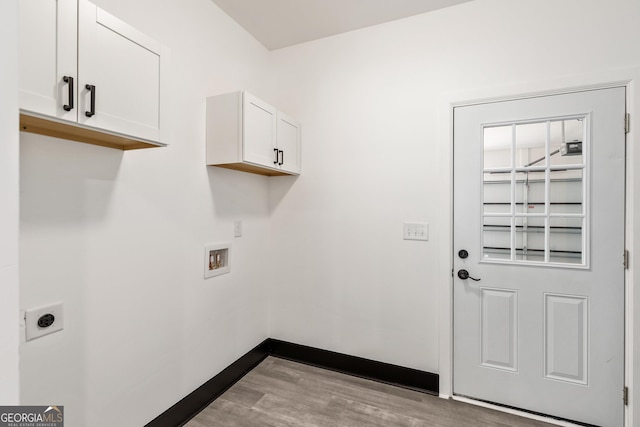 laundry area with hookup for a washing machine, hookup for an electric dryer, light wood finished floors, baseboards, and cabinet space