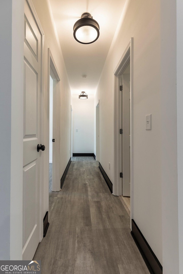hallway with wood finished floors