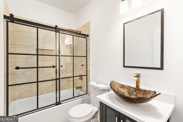 full bathroom with toilet, vanity, and bath / shower combo with glass door