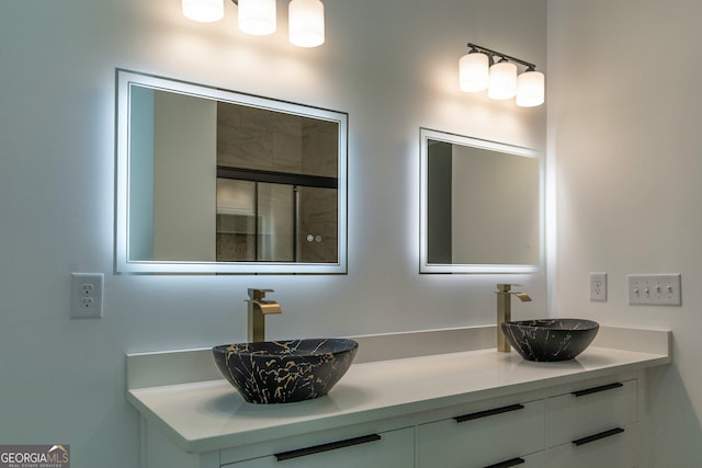 bathroom with a sink and double vanity
