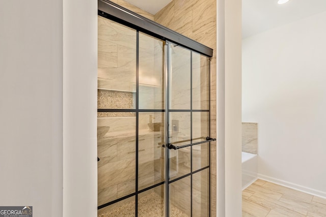 full bathroom with a bath, a stall shower, baseboards, and recessed lighting
