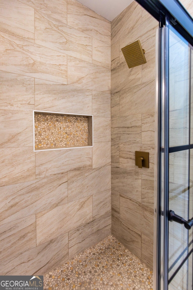 full bathroom with a tile shower