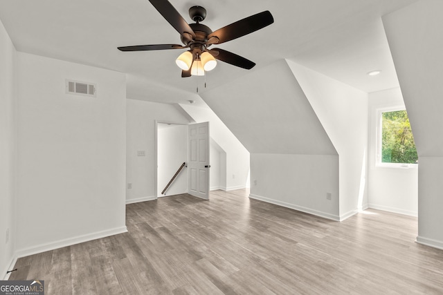 bonus room featuring visible vents, baseboards, wood finished floors, and ceiling fan