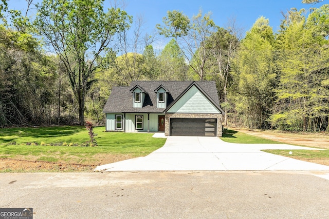 view of front of home with a front lawn, a shingled roof, a garage, and driveway