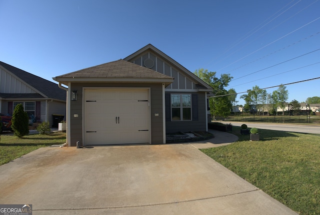exterior space with board and batten siding, an attached garage, a lawn, and driveway