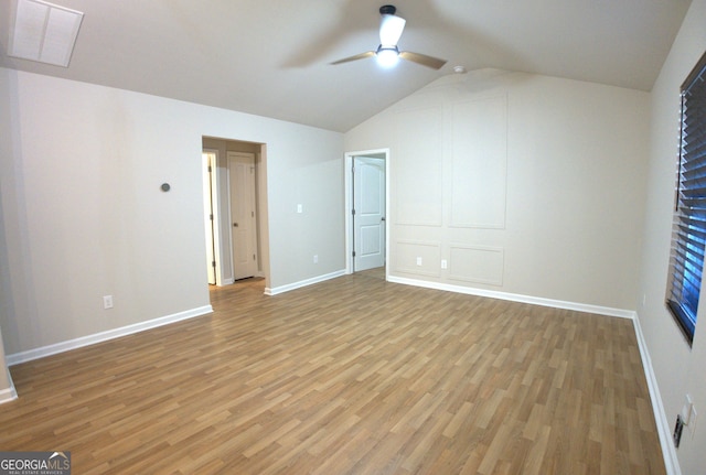unfurnished bedroom featuring visible vents, baseboards, light wood finished floors, and vaulted ceiling
