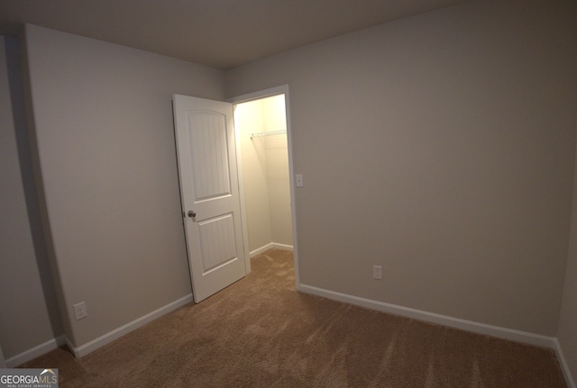 spare room with light carpet and baseboards