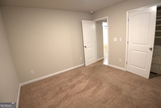 unfurnished bedroom with baseboards and carpet floors