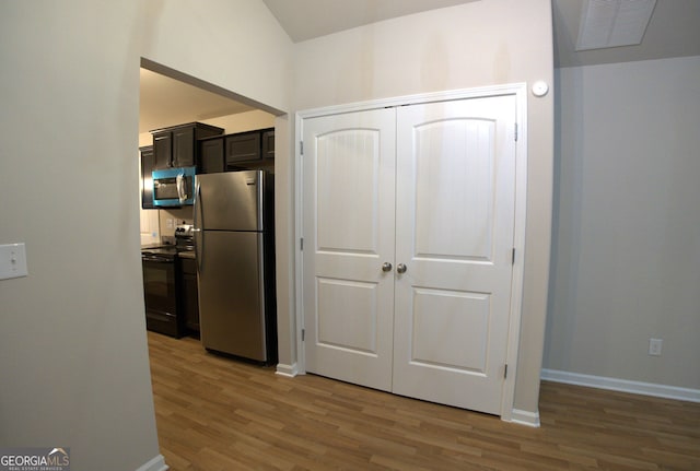 kitchen featuring light wood finished floors, visible vents, baseboards, and appliances with stainless steel finishes