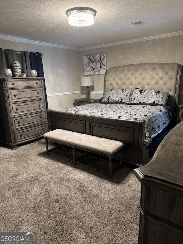 bedroom featuring visible vents, a textured ceiling, ornamental molding, and carpet floors