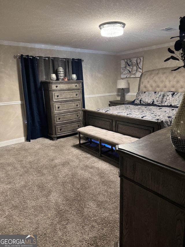 bedroom with ornamental molding, carpet floors, visible vents, and a textured ceiling