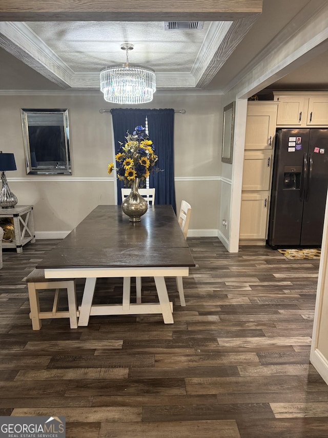 dining space featuring a chandelier, crown molding, and dark wood-type flooring