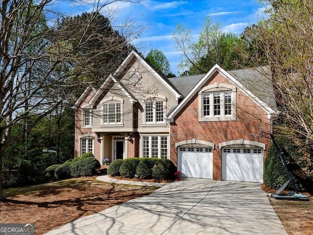traditional-style house with brick siding, a garage, and concrete driveway