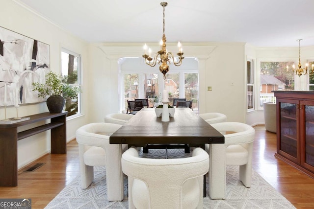 3711 Spinnaker Cir, Alpharetta, GA 30005 - dining area featuring a chandelier, light wood-style floors, and crown molding