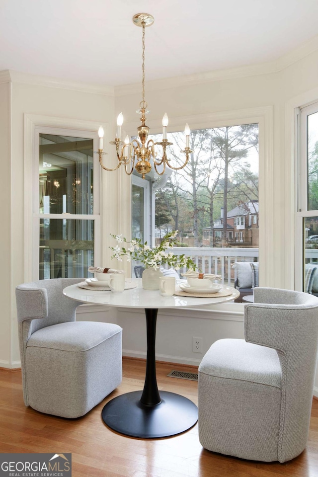 3711 Spinnaker Cir, Alpharetta, GA 30005 - dining area featuring a chandelier, wood finished floors, crown molding, and baseboards