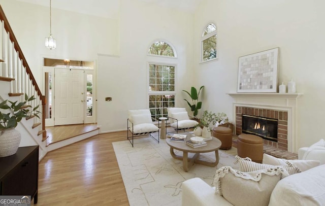 3711 Spinnaker Cir, Alpharetta, GA 30005 - living room featuring stairs, a high ceiling, light wood-type flooring, baseboards, and a chandelier