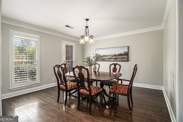 dining area featuring baseboards, visible vents, dark wood finished floors, and crown molding