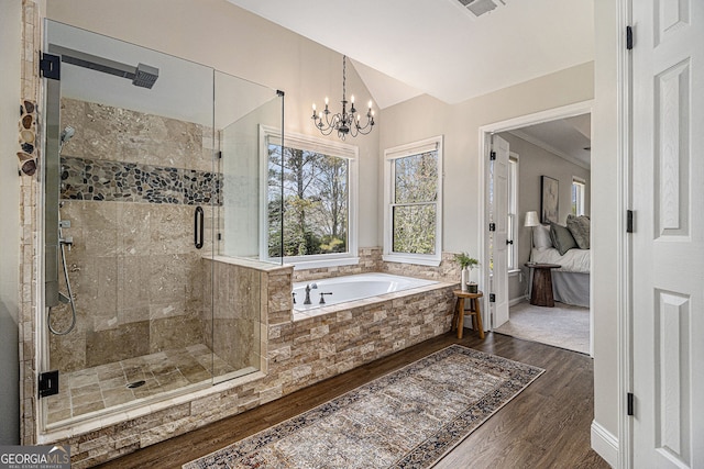 full bath featuring a garden tub, ensuite bath, a chandelier, wood finished floors, and a stall shower