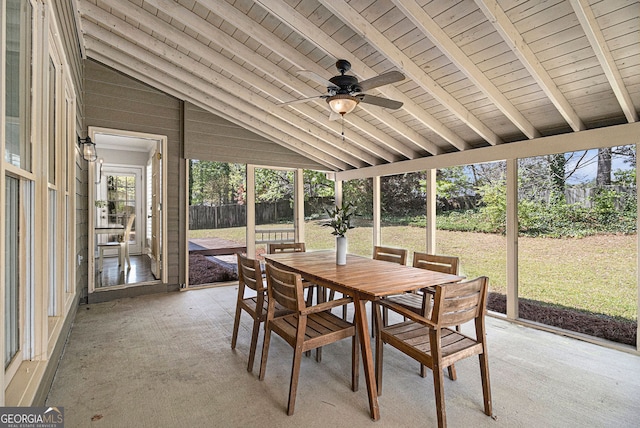 sunroom / solarium featuring outdoor dining area, beam ceiling, and ceiling fan