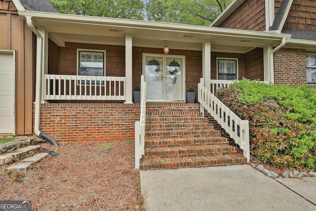 property entrance with covered porch and brick siding