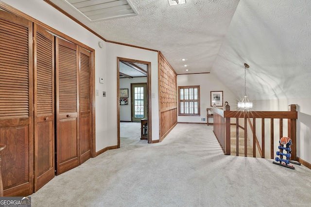 bonus room featuring baseboards, a textured ceiling, and light colored carpet