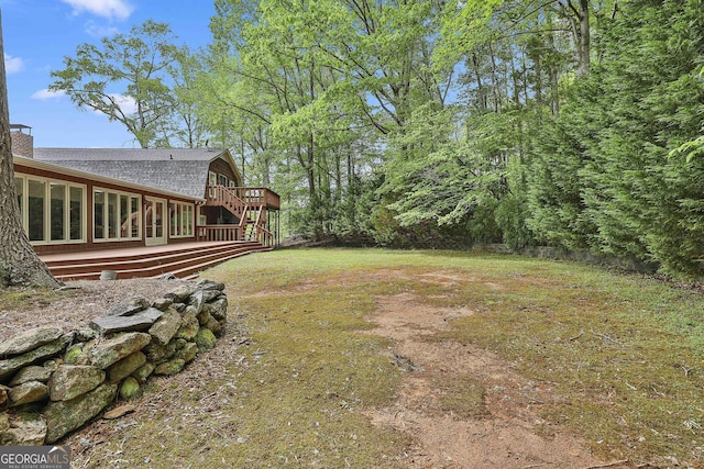 view of yard with stairway and a deck