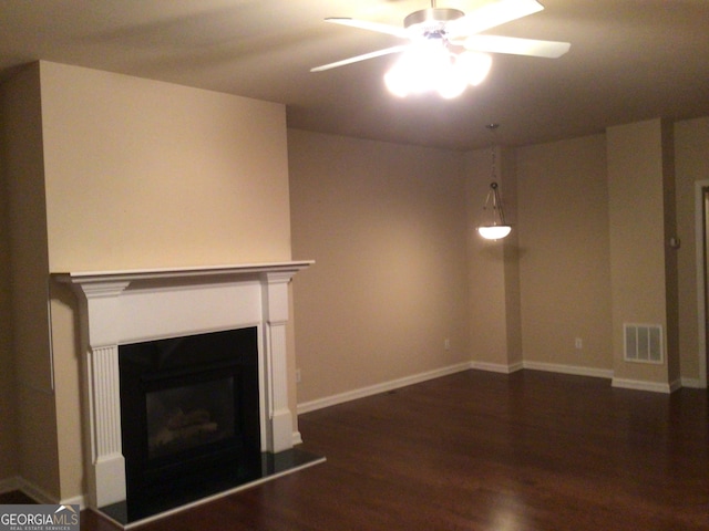 1186 Ridenour Blvd NW Unit 5, Kennesaw, GA 30152 - unfurnished living room with ceiling fan, dark wood-type flooring, a fireplace with raised hearth, and baseboards