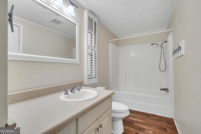 188 Paramount Dr, Eatonton, GA 31024 - full bath featuring a textured ceiling, vanity, visible vents, toilet, and wood finished floors