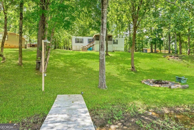 188 Paramount Dr, Eatonton, GA 31024 - view of yard with a dock and a fire pit