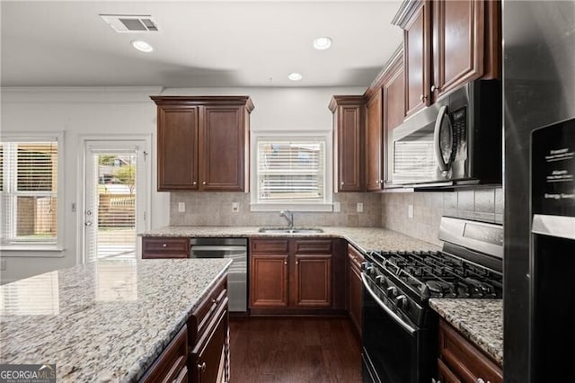 4735 Belcrest Way, Cumming, GA 30040 - kitchen with light stone counters, dark wood-type flooring, visible vents, appliances with stainless steel finishes, and a sink