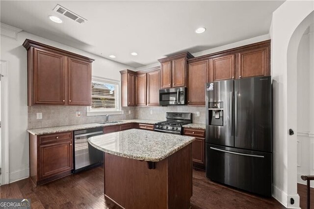 4735 Belcrest Way, Cumming, GA 30040 - kitchen featuring dark wood finished floors, visible vents, a center island, appliances with stainless steel finishes, and a sink