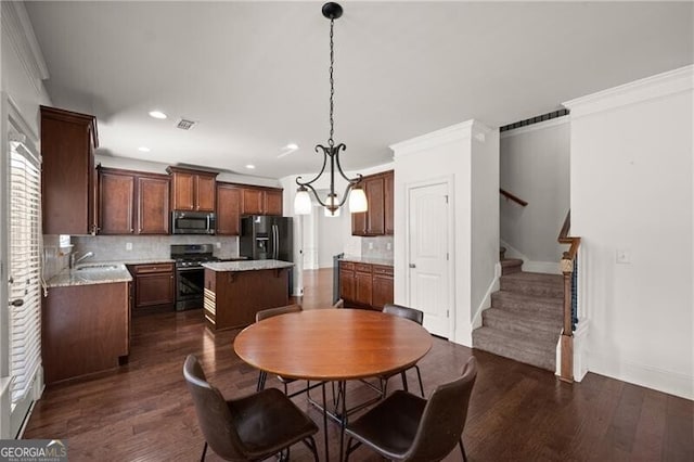 4735 Belcrest Way, Cumming, GA 30040 - dining area with dark wood-style flooring and crown molding