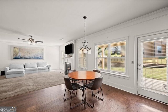 4735 Belcrest Way, Cumming, GA 30040 - dining room with dark wood-type flooring, ornamental molding, baseboards, and a fireplace