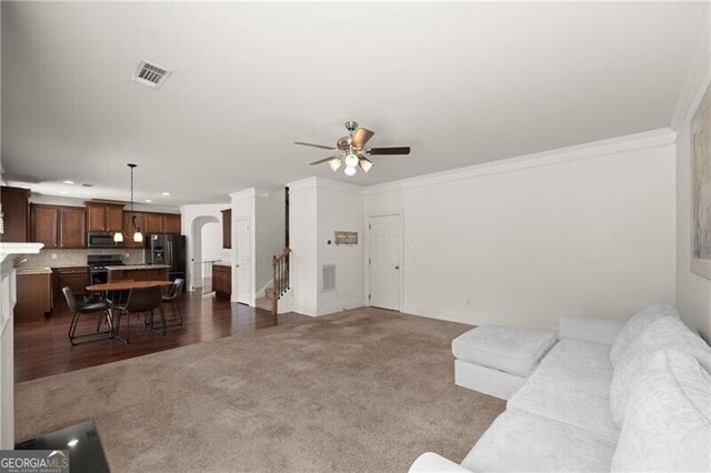 4735 Belcrest Way, Cumming, GA 30040 - living area featuring crown molding, a ceiling fan, visible vents, and carpet floors