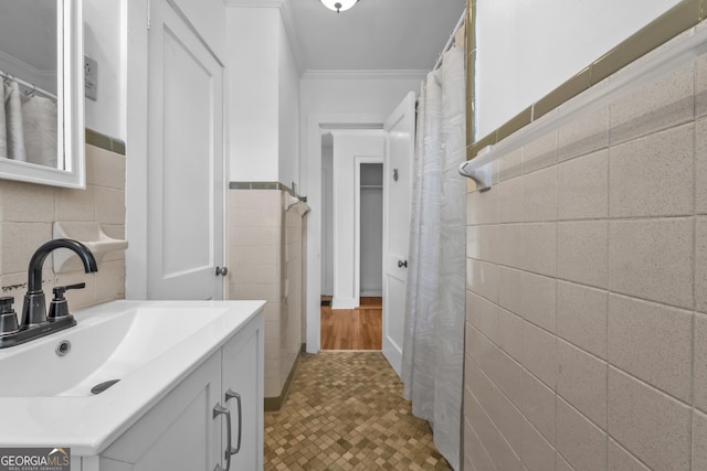 bathroom with vanity, tile walls, and ornamental molding