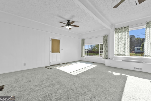 spare room with carpet, visible vents, and ceiling fan