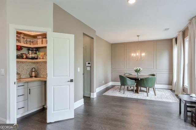 412 Nickajack Retreat Ln, Smyrna, GA 30082 - dining area with visible vents, a decorative wall, baseboards, a chandelier, and dark wood-style flooring