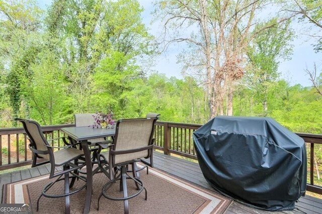 412 Nickajack Retreat Ln, Smyrna, GA 30082 - wooden deck with outdoor dining space, a forest view, and area for grilling